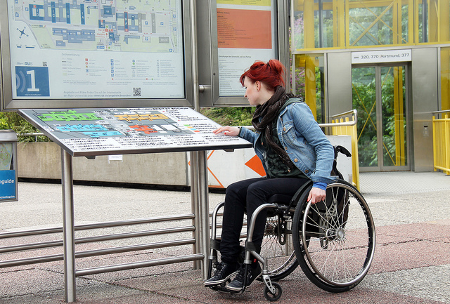 Vrouw in rolstoel zoekt informatie